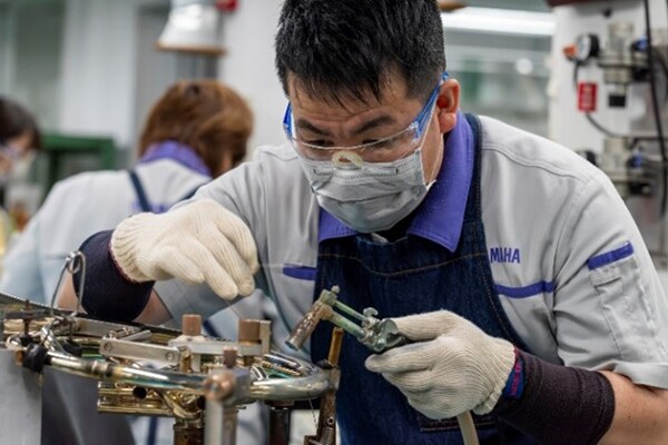 Rzemieślnik lutuje metalowe części, używając bezołowiowego lutu.